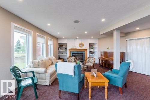#208 9926 100 Av, Fort Saskatchewan, AB - Indoor Photo Showing Living Room With Fireplace