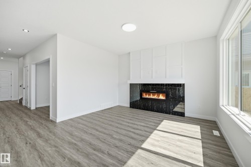 Contemporary fireplace with a black surround and linear firebox - 3 Pierwyck Loop, Spruce Grove, AB - Indoor With Fireplace