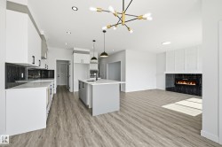 Open-concept living space with wood-finish flooring - 