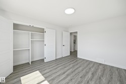 Neutral white walls complement light wood-finish flooring - 