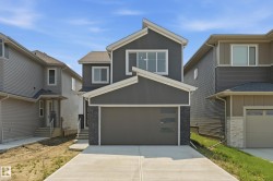 Contemporary two-story residence featuring a dark gray facade with white trim - 