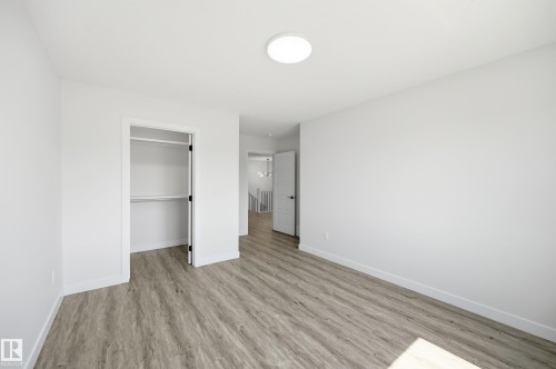 Bright room featuring neutral white walls and wood-finish flooring - 3 Pierwyck Loop, Spruce Grove, AB - Indoor Photo Showing Other Room