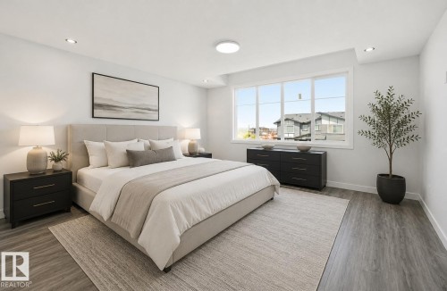 Bright room featuring expansive windows, recessed lighting, and wood-finish flooring - 3 Pierwyck Loop, Spruce Grove, AB - Indoor Photo Showing Bedroom