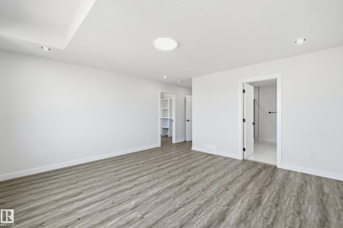Spacious room featuring wood-finish flooring and a neutral color palette - 3 Pierwyck Loop, Spruce Grove, AB - Indoor Photo Showing Other Room