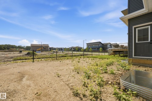 Rear exterior of property featuring gray horizontal siding and a wooden deck - 3 Pierwyck Loop, Spruce Grove, AB - Outdoor