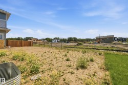 Expansive backyard space featuring a partial privacy fence and an existing chain link fence - 