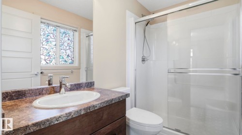 Bathroom vanity featuring a vessel sink, chrome faucet, and a patterned countertop - #361 7805 71 St Nw, Edmonton, AB - Indoor Photo Showing Bathroom