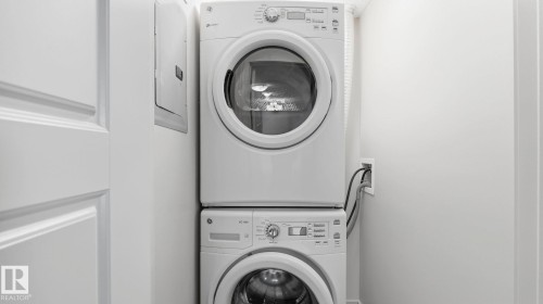 Stackable white front-load washer and dryer units - #361 7805 71 St Nw, Edmonton, AB - Indoor Photo Showing Laundry Room