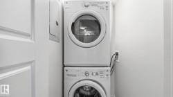 Stackable white front-load washer and dryer units - 