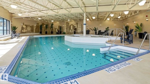 Indoor swimming pool featuring a tiled perimeter and integrated spa - #361 7805 71 St Nw, Edmonton, AB - Indoor Photo Showing Other Room With In Ground Pool