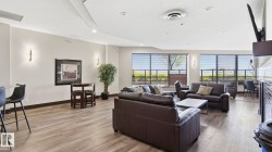 Spacious common area featuring wood-finish flooring, recessed lighting, and large windows with horizontal blinds - 