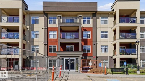Multi-story building featuring a contemporary facade with a contrasting color palette of deep gray, light beige, and red-brown panels - #361 7805 71 St Nw, Edmonton, AB - Outdoor With Balcony With Facade