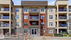 Multi-story building featuring a contemporary facade with a contrasting color palette of deep gray, light beige, and red-brown panels - 