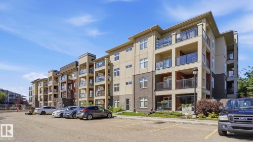 Contemporary multi-story building featuring a neutral-toned facade with contrasting dark accents and multiple private balconies - #361 7805 71 St Nw, Edmonton, AB - Outdoor With Balcony With Facade