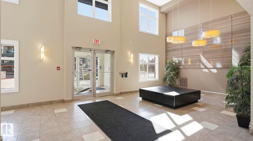 Bright entryway featuring tall ceilings and ample natural light through multiple windows - #361 7805 71 St Nw, Edmonton, AB - Indoor Photo Showing Other Room