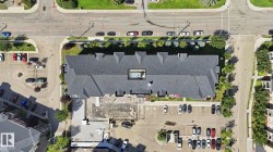 Multi-unit property with a dark shingle roof and multiple gables - 