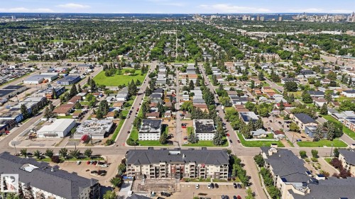 Aerial perspective showcasing a mixed-use urban landscape featuring residential areas, commercial properties, and green spaces - #361 7805 71 St Nw, Edmonton, AB - Outdoor With View
