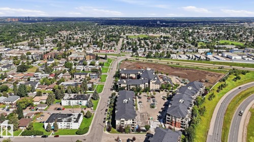 Aerial perspective highlighting a multi-building residential development with dark-toned roofs and multi-level facades - #361 7805 71 St Nw, Edmonton, AB - Outdoor With View