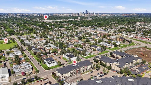 Aerial perspective showcasing a residential area with a prominent city skyline in the distance - #361 7805 71 St Nw, Edmonton, AB - Outdoor With View