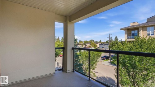 Covered balcony with durable flooring and clear panel railing - #361 7805 71 St Nw, Edmonton, AB - Outdoor With Balcony With Exterior