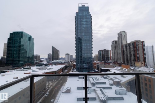 Cityscape panorama featuring multiple high-rise buildings and a glass balcony railing - #1201 10238 103 St Nw, Edmonton, AB - Outdoor With Balcony