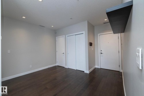 Recessed lighting illuminates the wood-finish flooring - #1201 10238 103 St Nw, Edmonton, AB - Indoor Photo Showing Other Room