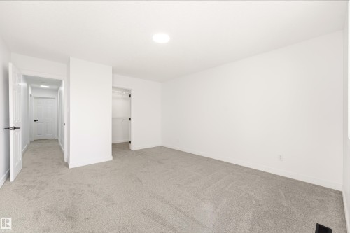 Spacious room featuring light gray carpet flooring, white walls, and a recessed ceiling light - #4 7604 29 Av Nw, Edmonton, AB - Indoor Photo Showing Other Room