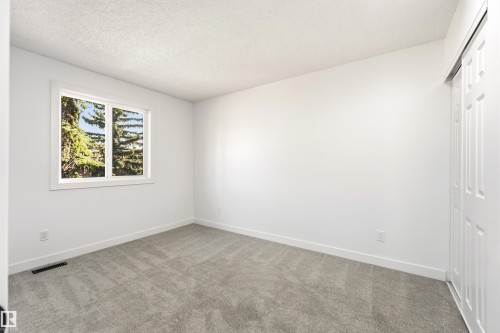 Room with light gray carpet, white walls, and white trim - #4 7604 29 Av Nw, Edmonton, AB - Indoor Photo Showing Other Room