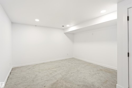 Neutral-toned carpeted room featuring white walls and recessed ceiling lighting - #4 7604 29 Av Nw, Edmonton, AB - Indoor Photo Showing Other Room