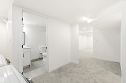 Spacious lower level featuring plush gray carpeting throughout, recessed lighting, and crisp white walls - 