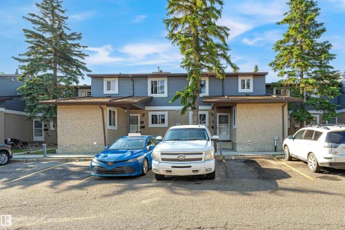 Townhome exterior featuring gray siding and stucco finishes - #4 7604 29 Av Nw, Edmonton, AB - Outdoor With Facade