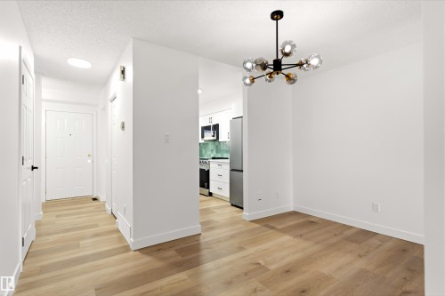 Modern open-concept interior featuring light wood-finish flooring throughout - #4 7604 29 Av Nw, Edmonton, AB - Indoor Photo Showing Other Room