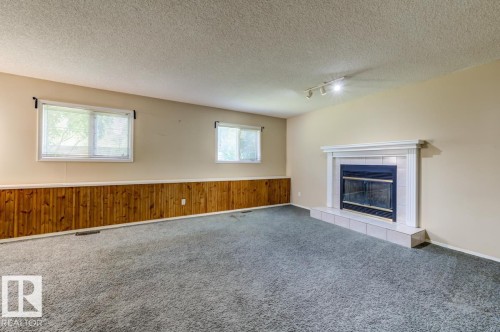3908 28 Avenue Nw, Edmonton, AB - Indoor Photo Showing Living Room With Fireplace