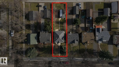 Aerial view showcasing the property with a prominent peaked roofline and an extended rectangular lot - 12235 104 Street Nw, Edmonton, AB - 