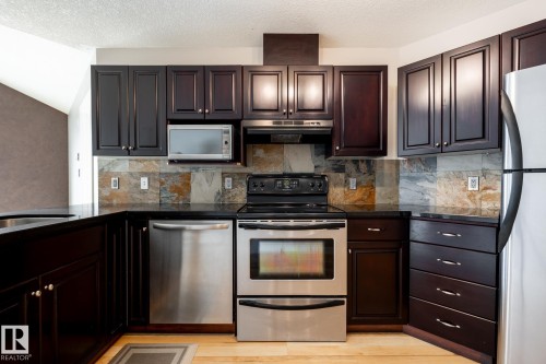 #304 9336 Jasper Av Nw, Edmonton, AB - Indoor Photo Showing Kitchen With Stainless Steel Kitchen