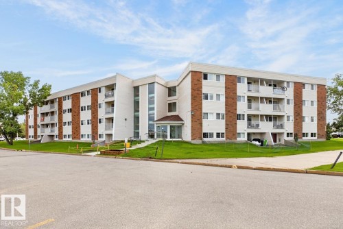 Multi-story building featuring a brick and white panel facade - #5 11265 31 Av Nw, Edmonton, AB - Outdoor With Facade