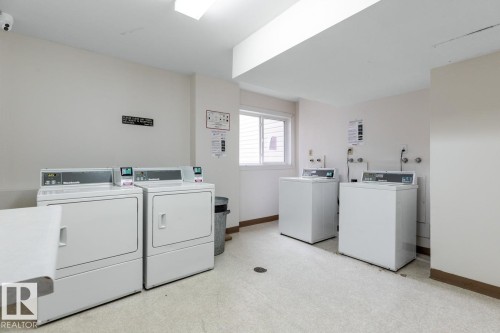 Community laundry room featuring multiple washing machines and dryers - #5 11265 31 Av Nw, Edmonton, AB - Indoor Photo Showing Laundry Room