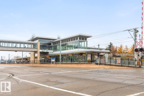 Modern LRT transit station with a pedestrian overpass, extensive glazing, and multiple platforms - #5 11265 31 Av Nw, Edmonton, AB - Outdoor