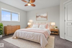 Bedroom featuring a ceiling fan with integrated lighting, a large window, and a paneled door - 