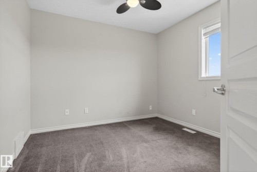 Bedroom featuring light gray walls, gray carpet, white trim, a single window, and a ceiling fan with integrated lighting - 96 Dalquist Bay, Leduc, AB - Indoor Photo Showing Other Room