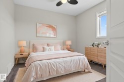 Bedroom featuring a ceiling fan with integrated lighting, a window with blinds, and dark carpet flooring - 