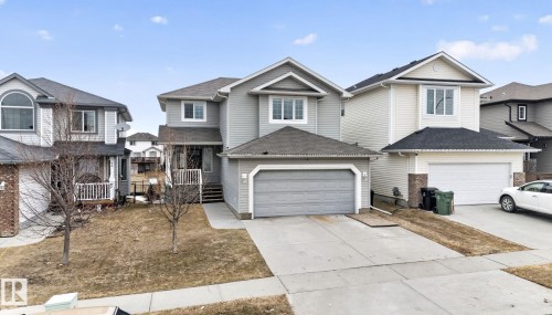 Two-story residential architecture with light gray siding and a dark shingle roof - 96 Dalquist Bay, Leduc, AB - Outdoor With Facade