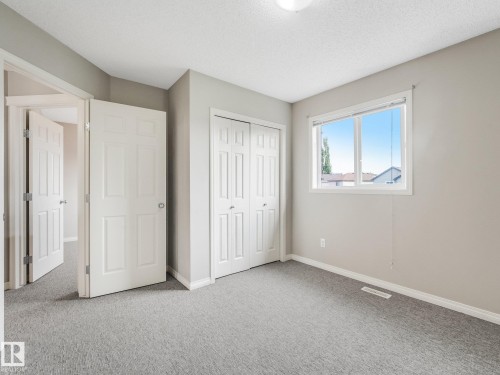 Interior room with light gray walls and plush gray carpeting - 11844 21 Avenue Sw, Edmonton, AB - Indoor Photo Showing Other Room