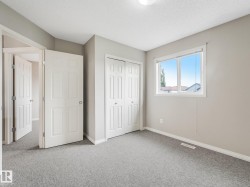 Interior room with light gray walls and plush gray carpeting - 