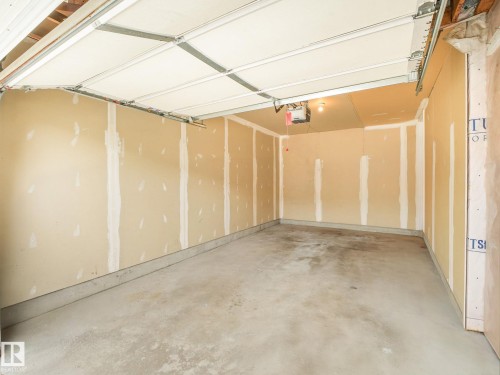 Spacious interior room featuring unfinished drywall with metal stud framing, polished concrete flooring, and recessed ceiling fixtures - 11844 21 Avenue Sw, Edmonton, AB - Indoor
