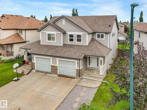 Two-story residence featuring light gray siding and stone accents - 11844 21 Avenue Sw, Edmonton, AB - Outdoor With Facade