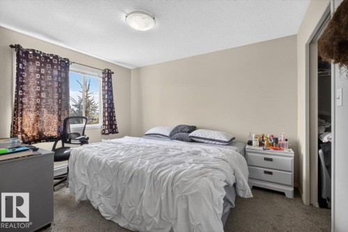 Neutral paint tones throughout - #421 1180 Hyndman Rd Nw, Edmonton, AB - Indoor Photo Showing Bedroom