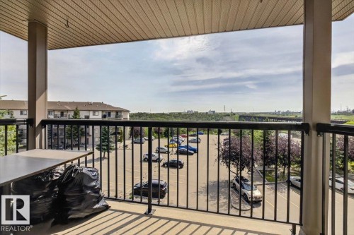 Private balcony with a metal railing and a textured ceiling finish - #421 1180 Hyndman Rd Nw, Edmonton, AB - Outdoor With Exterior