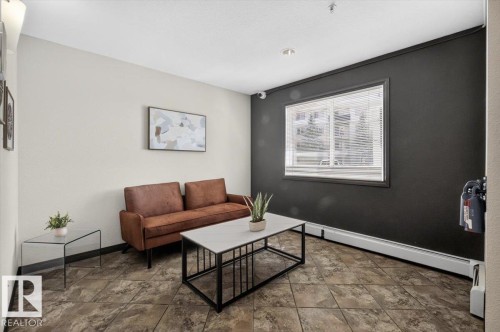 Couch area in the lobby - #421 1180 Hyndman Rd Nw, Edmonton, AB - Indoor Photo Showing Living Room