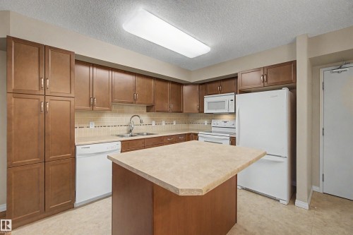 #215 4450 Mccrae Av Nw, Edmonton, AB - Indoor Photo Showing Kitchen With Double Sink